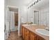 This primary bathroom features a dual sink vanity and separate shower and toilet room at 8501 Hackamore Rd, Littleton, CO 80125