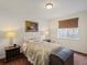 Cozy bedroom with neutral-toned bedding, classic décor, and a window for natural light at 8501 Hackamore Rd, Littleton, CO 80125