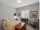 Comfortable bedroom with a well-lit window, rocking chair, and wooden storage chest at 8501 Hackamore Rd, Littleton, CO 80125