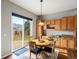 Dining area with sliding door access to the backyard and wooden cabinets at 8501 Hackamore Rd, Littleton, CO 80125