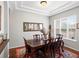 Formal dining room with a dark wood table, seating for six, and elegant decor at 8501 Hackamore Rd, Littleton, CO 80125