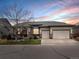 Charming single-Gathering home with a three-car garage, well-maintained lawn at sunset at 8501 Hackamore Rd, Littleton, CO 80125