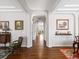 Elegant hallway with hardwood floors, arched doorways, and decorative wall art at 8501 Hackamore Rd, Littleton, CO 80125