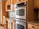 This kitchen features stainless steel double ovens and plentiful wooden cabinets for storage at 8501 Hackamore Rd, Littleton, CO 80125