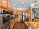 Kitchen features stainless steel appliances, wooden cabinetry, and granite countertops at 8501 Hackamore Rd, Littleton, CO 80125