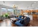 Living room with large windows, hardwood floors, plants, and blue sofa at 8501 Hackamore Rd, Littleton, CO 80125