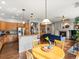 Open concept kitchen and living space, featuring modern lighting and a fireplace at 8501 Hackamore Rd, Littleton, CO 80125