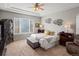 Spacious main bedroom with tray ceiling, window views, and stylish furnishings at 8501 Hackamore Rd, Littleton, CO 80125