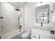 Stylish bathroom boasts marble-look shower, black fixtures, and floating vanity, plus a modern black-framed mirror at 4647 Bryant St, Denver, CO 80211