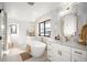 Bright, spa-like bathroom with standalone tub, double vanity and elegant finishes at 4647 Bryant St, Denver, CO 80211