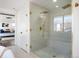 Bright bathroom featuring a glass enclosed shower with dual shower heads and modern finishes at 4647 Bryant St, Denver, CO 80211