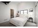 Serene bedroom with ensuite bath featuring neutral tones, natural light, and contemporary décor at 4647 Bryant St, Denver, CO 80211