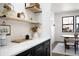 Bright dining area featuring quartz countertops, floating shelves and modern finishes at 4647 Bryant St, Denver, CO 80211