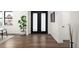 Elegant foyer with hardwood floors, white walls, and black framed double doors at 4647 Bryant St, Denver, CO 80211