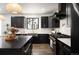 This stunning kitchen features black cabinets, gold hardware, and modern appliances at 4647 Bryant St, Denver, CO 80211