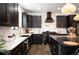 This stunning kitchen features black cabinets, gold hardware, and modern appliances at 4647 Bryant St, Denver, CO 80211
