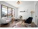 Stylish home office with a glass desk, plush chairs, and a skyline art piece at 4647 Bryant St, Denver, CO 80211