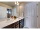 Modern bathroom with double vanity, large mirror, and linen closet at 15726 E Otero Cir, Centennial, CO 80112