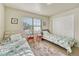 Well-lit bedroom featuring two twin beds and a large window at 15726 E Otero Cir, Centennial, CO 80112