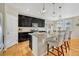 Modern kitchen with dark cabinetry, granite countertops, and island at 15726 E Otero Cir, Centennial, CO 80112