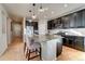 Modern kitchen with granite countertops, stainless steel appliances, and dark wood cabinets at 15726 E Otero Cir, Centennial, CO 80112