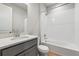 Full bathroom with white subway tiles, shower and bath, and a single sink vanity at 1825 Morgan Dr, Erie, CO 80516