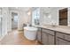 Luxurious bathroom featuring a soaking tub, double vanities, and a window with a neighborhood view at 1825 Morgan Dr, Erie, CO 80516
