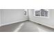 Bright bedroom featuring neutral carpet, base trim and two windows for natural light at 1825 Morgan Dr, Erie, CO 80516