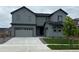 Stylish two-story gray home featuring a two-car garage, concrete driveway, and neatly manicured lawn at 1825 Morgan Dr, Erie, CO 80516