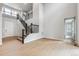Grand foyer with soaring ceilings, staircase with black railing, and wood floors at 1825 Morgan Dr, Erie, CO 80516