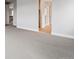 Hallway shows the neutral carpet and light wood flooring visible, highlighting the home's design at 1825 Morgan Dr, Erie, CO 80516