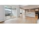 Open kitchen and dining area with modern appliances and hardwood floors leading to an outdoor deck at 1825 Morgan Dr, Erie, CO 80516
