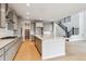 Bright kitchen with quartz island, wood floors, and stainless steel appliances at 1825 Morgan Dr, Erie, CO 80516