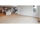 Open-concept living space with wood floors, seamlessly connecting the kitchen and staircase at 1825 Morgan Dr, Erie, CO 80516
