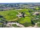 Expansive aerial view showcasing the property's land, barns, outbuildings, and serene rural setting at 11475 Us Highway 85, Littleton, CO 80125