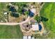 Aerial view of a rural property featuring multiple buildings, trees, and fields at 11475 Us Highway 85, Littleton, CO 80125
