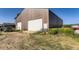 Exterior view of a brown metal barn with white doors, surrounded by green grass at 11475 Us Highway 85, Littleton, CO 80125