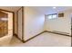 Finished basement features a small window, neutral carpet, and a door to another room at 11475 Us Highway 85, Littleton, CO 80125