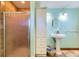 Bathroom featuring tile flooring, a walk-in shower, and a pedestal sink at 11475 Us Highway 85, Littleton, CO 80125