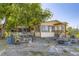 Quaint single-Gathering residence featuring a charming exterior, cozy porch, and peaceful yard setting at 11475 Us Highway 85, Littleton, CO 80125