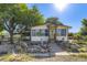 Inviting single-Gathering residence with a cozy porch and decorative touches surrounded by lush greenery and mature trees at 11475 Us Highway 85, Littleton, CO 80125