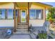 Charming home featuring a welcoming front entrance with wooden steps and meticulously curated landscaping at 11475 Us Highway 85, Littleton, CO 80125
