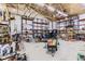 Spacious garage with high ceilings and ample storage space, featuring a vintage automobile and organizational shelving at 11475 Us Highway 85, Littleton, CO 80125