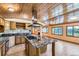Kitchen featuring granite counters, stainless steel appliances, a wood ceiling and island with cooktop at 11475 Us Highway 85, Littleton, CO 80125