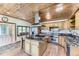 Gourmet kitchen with a wood ceiling, granite counters, stainless appliances, and large windows at 11475 Us Highway 85, Littleton, CO 80125