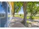 Exterior view of a concrete patio with mature trees overlooking a green lawn at 11475 Us Highway 85, Littleton, CO 80125