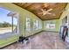 Bright sunroom featuring a wood ceiling, tiled floor, and many windows with outdoor views at 11475 Us Highway 85, Littleton, CO 80125