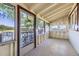 Well-lit sunroom with screen windows and a door leading to the outside at 11475 Us Highway 85, Littleton, CO 80125