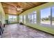 Light-filled sunroom with numerous windows, a ceiling fan, and a view of the yard at 11475 Us Highway 85, Littleton, CO 80125