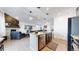 Modern kitchen open to living space, featuring island with seating at 24289 E Brandt Ave, Aurora, CO 80016